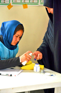A woman has her finger marked with ink to confirm she has voted. (Photo: Jawad Kia)